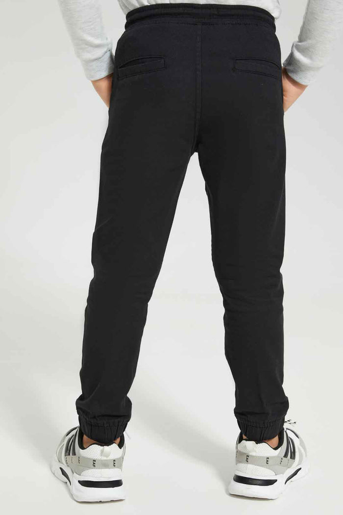 Redtag-Boys-Black-Elasticated-Waist-Jogger-BOY-Trousers,-BTS,-Category:Trousers,-Colour:Black,-Deals:New-In,-Dept:Boys,-Filter:Boys-(2-to-8-Yrs),-New-In-BOY-APL,-Non-Sale,-S23A,-Section:Boys-(0-to-14Yrs),-VLM-Boys-2 to 8 Years